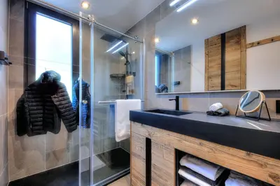 a bathroom with a sink and a glass shower at Appartement familial au pied de la télécabine 4* in Saint-Gervais-les-Bains
