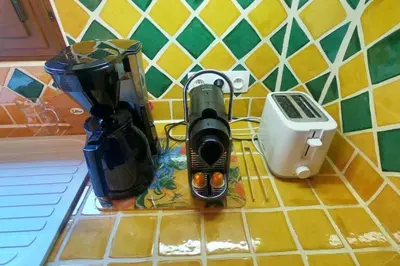 a kitchen counter with various appliances on a counter top at The Historic Chalet Les Allognes Mont-Blanc views in Les Houches
