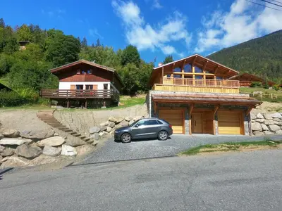 a car parked in front of a house at The Historic Chalet Les Allognes Mont-Blanc views in Les Houches