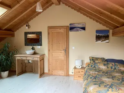 a room with a couch and a table and a door at Les deux loups in Samoëns