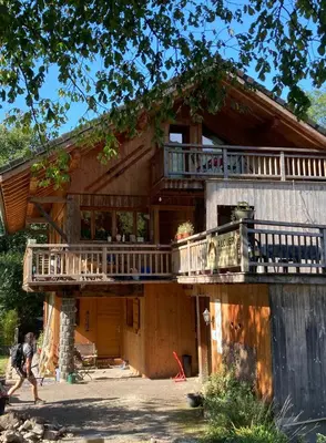 a house being constructed with a wrap around deck at Les deux loups in Samoëns