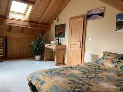 a bedroom with a bed and a desk and a window at Les deux loups in Samoëns