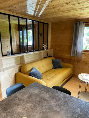 a living room with a couch and a table at Marmotte du Jaillet Cosy and charmant appartement in Demi-Quartier