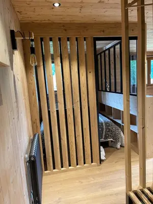 a wooden staircase in a house with a cat in it at Marmotte du Jaillet Cosy and charmant appartement in Demi-Quartier