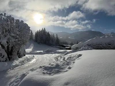 a snow covered road with footprints in the snow at Marmotte du Jaillet Cosy and charmant appartement in Demi-Quartier