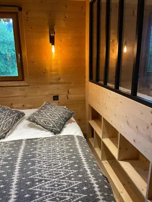 a room with two beds in a wooden cabin at Marmotte du Jaillet Cosy and charmant appartement in Demi-Quartier