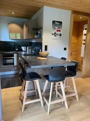a kitchen with a large wooden table and chairs at Marmotte du Jaillet Cosy and charmant appartement in Demi-Quartier