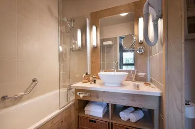 a bathroom with a sink and a shower and a tub at Résidence Pierre & Vacances Premium Les Terrasses d'Eos in Flaine