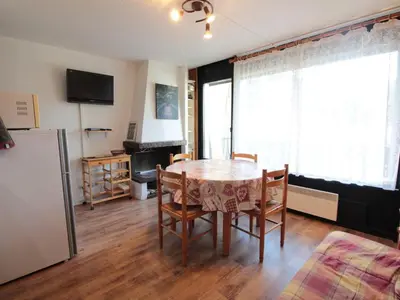 a bedroom with a large bed with wooden walls at Appartement cosy 2 pièces pour 4 pers, proche centre et pistes, avec balcon, parking et équipements inclus - FR-1-572-236 in Arâches-la-Frasse