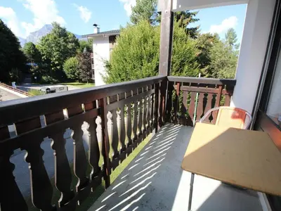 a balcony with a bench and a view of trees at Appartement cosy 2 pièces pour 4 pers, proche centre et pistes, avec balcon, parking et équipements inclus - FR-1-572-236 in Arâches-la-Frasse