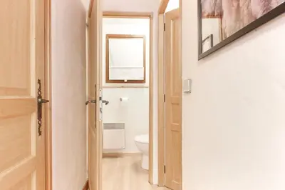 a bathroom with a toilet and a window at Violette de Cham - Jardin privé - Vue Mont Blanc in Chamonix-Mont-Blanc