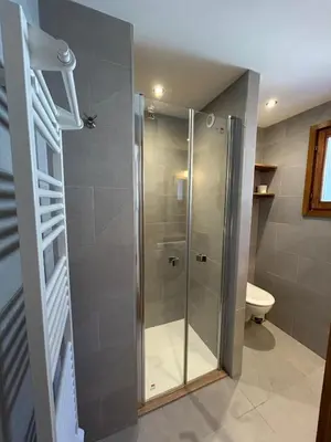 a shower with a glass door in a bathroom at Violette de Cham - Jardin privé - Vue Mont Blanc in Chamonix-Mont-Blanc