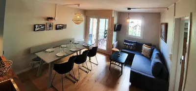 a living room with a table and a blue couch at La Rivière - Aiguille du Midi in Chamonix-Mont-Blanc