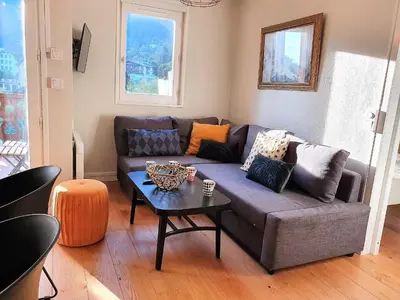 a living room with a couch and a table at La Rivière - Aiguille du Midi in Chamonix-Mont-Blanc
