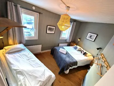 a bedroom with two beds and a lamp at La Rivière - Aiguille du Midi in Chamonix-Mont-Blanc