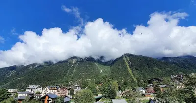 a group of houses in front of a mountain at La Rivière - Aiguille du Midi in Chamonix-Mont-Blanc