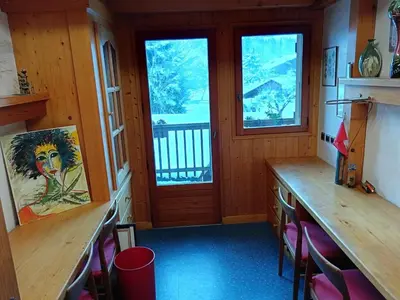 a room with wooden counters and a door with windows at Le chalet de Julbert in Combloux
