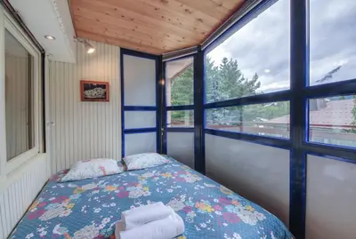 a bedroom with a bed in a room with a window at Gaillands North in Chamonix-Mont-Blanc