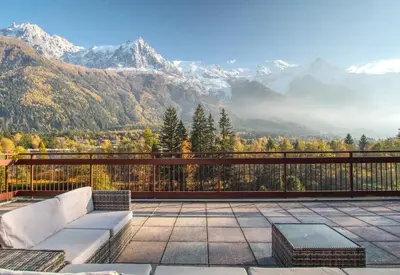 a balcony with a couch and a view of mountains at Gaillands North in Chamonix-Mont-Blanc