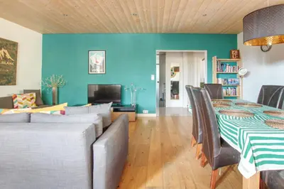 a living room with a couch and a table with chairs at Gaillands North in Chamonix-Mont-Blanc