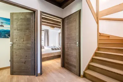 a room with a staircase and a bedroom at Chalet Jatoba Chamonix - by EMERALD STAY in Chamonix-Mont-Blanc