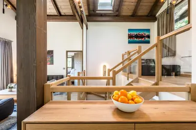 a bowl of oranges on a wooden table in a room at Chalet Jatoba Chamonix - by EMERALD STAY in Chamonix-Mont-Blanc