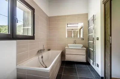 a bathroom with a tub and a sink at Chalet Jatoba Chamonix - by EMERALD STAY in Chamonix-Mont-Blanc