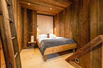 a bedroom with a bed in a wooden room at Maison du Roi - Happy Rentals in Chamonix-Mont-Blanc