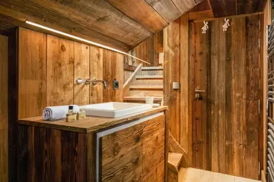a bathroom with a sink and wooden walls at Maison du Roi - Happy Rentals in Chamonix-Mont-Blanc