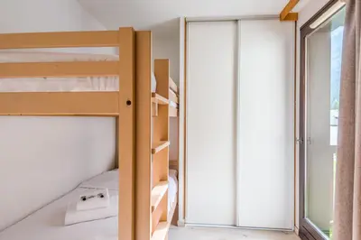 a bedroom with bunk beds and a window at Joli appartement vue Mont Blanc 3 balcons et parking - Welkeys in Chamonix-Mont-Blanc