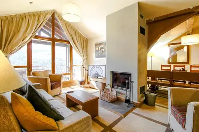 a living room with a couch and a fireplace at Exceptional 3 bed Penthouse with fireplace and stunning views in Flaine