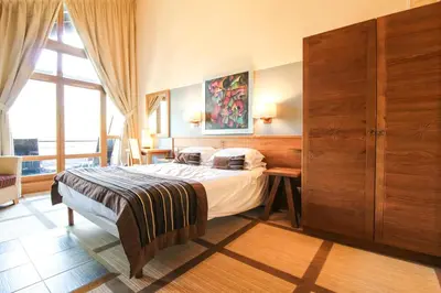 a bedroom with a bed and a large window at Exceptional 3 bed Penthouse with fireplace and stunning views in Flaine
