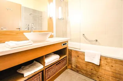 a bathroom with a sink and a tub at Exceptional 3 bed Penthouse with fireplace and stunning views in Flaine