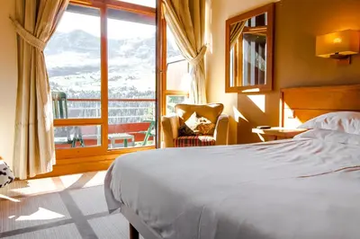 a bedroom with a bed and a large window at Exceptional 3 bed Penthouse with fireplace and stunning views in Flaine