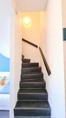 a staircase in a room with a bed at Résidence Les Terrasses De Veret - Appartement lumineux · Au pied des pistes · Piscine · Spa MAE-5444 in Flaine