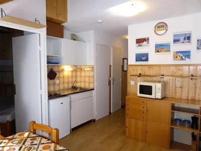 a kitchen with white cabinets and a microwave at Résidence Combettes - Combettes D292 MAE-5624 in Les Contamines-Montjoie