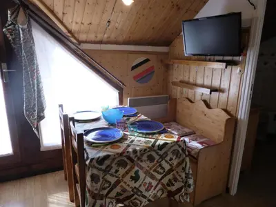 a table in a tiny house with a tv at Résidence Combettes - Combettes D292 MAE-5624 in Les Contamines-Montjoie