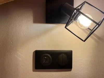 a light attached to a wall with a light switch at Chalet cosy proche Tramway du Mont-Blanc et centre in Saint-Gervais-les-Bains