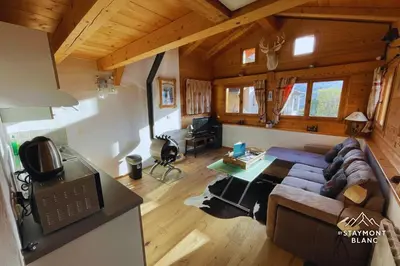 a living room with a couch and a table at Chalet cosy proche Tramway du Mont-Blanc et centre in Saint-Gervais-les-Bains