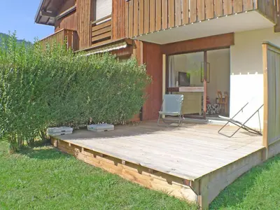a wooden deck in front of a house at Studio coquet avec terrasse, calme et parking à Samoëns - FR-1-629-86 in Samoëns