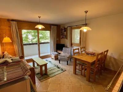 a kitchen and living room with a table and chairs at T3 calme à Samoëns avec Wifi et Parking - FR-1-629-45 in Samoëns