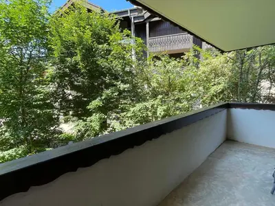 a balcony with a view of trees and a building at T3 calme à Samoëns avec Wifi et Parking - FR-1-629-45 in Samoëns