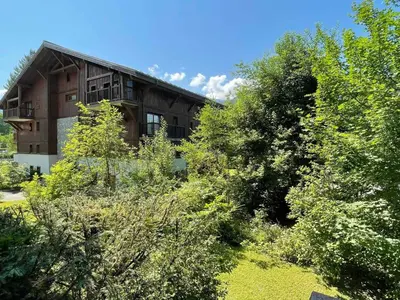a building with a lot of trees in front of it at T3 calme à Samoëns avec Wifi et Parking - FR-1-629-45 in Samoëns