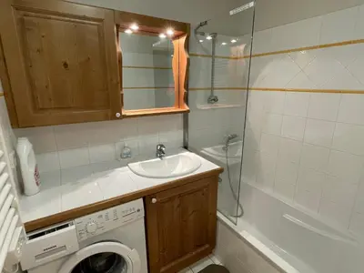 a bathroom with a sink and a washing machine at T3 calme à Samoëns avec Wifi et Parking - FR-1-629-45 in Samoëns