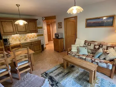 a living room with a couch and a table at T3 calme à Samoëns avec Wifi et Parking - FR-1-629-45 in Samoëns