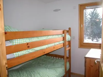 a bunk bed in a room with a window at Charmant T4 à Samoëns avec Balcon et Parking, 6 Pers. - FR-1-629-87 in Samoëns