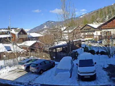 two cars parked in a parking lot covered in snow at Charmant T4 à Samoëns avec Balcon et Parking, 6 Pers. - FR-1-629-87 in Samoëns