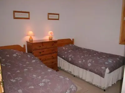 a bedroom with two beds and a dresser with two lamps at Charmant T4 à Samoëns avec Balcon et Parking, 6 Pers. - FR-1-629-87 in Samoëns