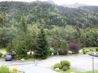 a parking lot in front of a mountain at Résidence L'enclave - Enclave J717 MAE-5744 in Les Contamines-Montjoie