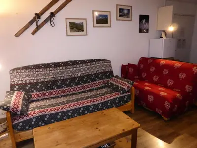 a living room with a couch and a blanket at Résidence L'enclave - Enclave J717 MAE-5744 in Les Contamines-Montjoie